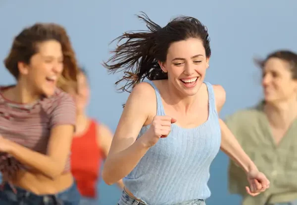 Amigas adolescentes corriendo felices sin limitación de movimiento